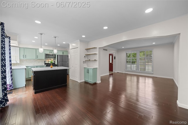 1633 Fleetwood Dr, Troy, MI 48098 - kitchen with green cabinetry, appliances with stainless steel finishes, light countertops, a center island, and open shelves