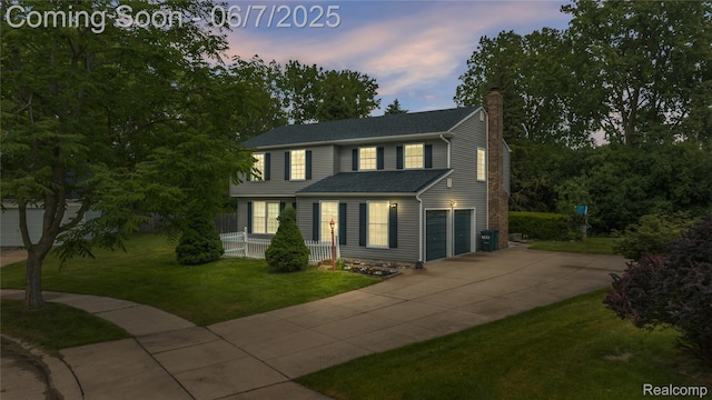 1633 Fleetwood Dr, Troy, MI 48098 - view of front of house with a chimney, concrete driveway, covered porch, a front yard, and an attached garage