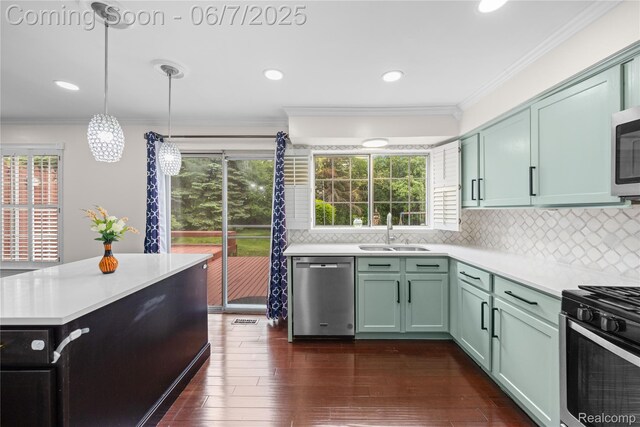 1633 Fleetwood Dr, Troy, MI 48098 - kitchen featuring stainless steel appliances, a sink, light countertops, crown molding, and plenty of natural light