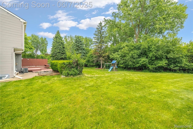 1633 Fleetwood Dr, Troy, MI 48098 - view of green lawn with a playground and cooling unit
