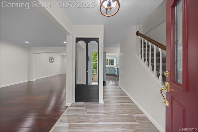 1633 Fleetwood Dr, Troy, MI 48098 - entrance foyer with stairs, baseboards, recessed lighting, light wood-style flooring, and a chandelier