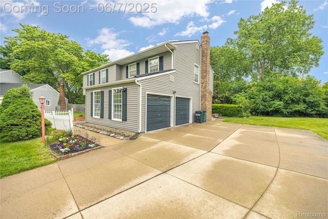 1633 Fleetwood Dr, Troy, MI 48098 - view of front of home featuring a chimney, an attached garage, and concrete driveway