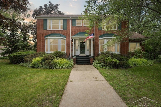 2505 Court St, Saginaw, MI 48602 - view of front of house with a lawn and brick siding