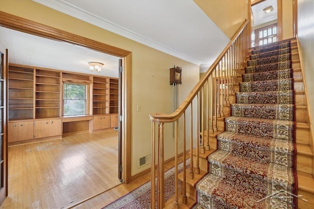 2505 Court St, Saginaw, MI 48602 - stairway featuring hardwood / wood-style flooring, crown molding, baseboards, and built in shelves