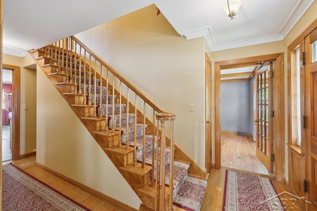 2505 Court St, Saginaw, MI 48602 - entrance foyer featuring wood finished floors, ornamental molding, stairway, and baseboards