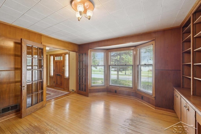 2505 Court St, Saginaw, MI 48602 - entryway with wooden walls and light wood-style floors