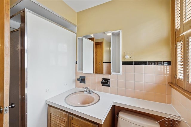 2505 Court St, Saginaw, MI 48602 - bathroom with toilet, vanity, and tasteful backsplash