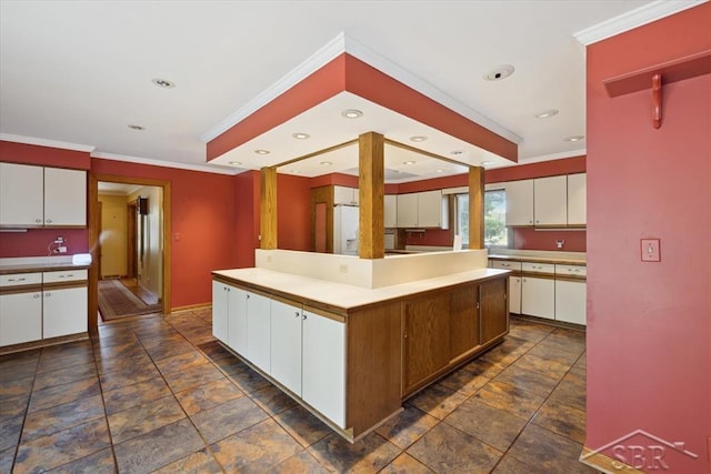 2505 Court St, Saginaw, MI 48602 - kitchen with white cabinetry, stone tile floors, crown molding, a kitchen island, and light countertops