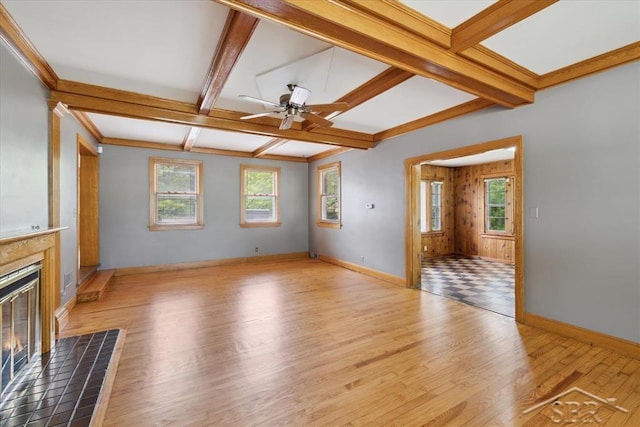 2505 Court St, Saginaw, MI 48602 - unfurnished living room with a glass covered fireplace, wood finished floors, beamed ceiling, ceiling fan, and coffered ceiling