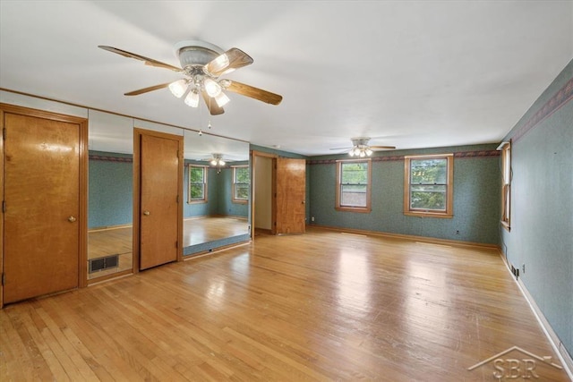 2505 Court St, Saginaw, MI 48602 - empty room with light wood-type flooring, ceiling fan, and baseboards