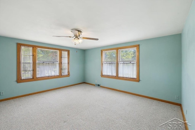 2505 Court St, Saginaw, MI 48602 - spare room featuring a ceiling fan, carpet flooring, and baseboards