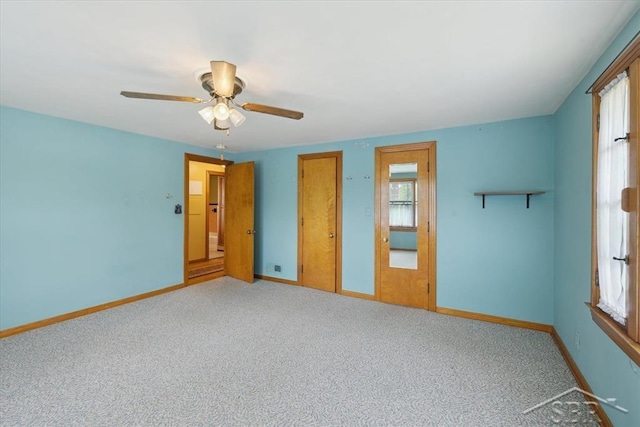 2505 Court St, Saginaw, MI 48602 - unfurnished bedroom featuring baseboards, carpet flooring, and a ceiling fan
