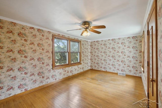 2505 Court St, Saginaw, MI 48602 - empty room featuring light wood-style floors, a ceiling fan, baseboards, and crown molding