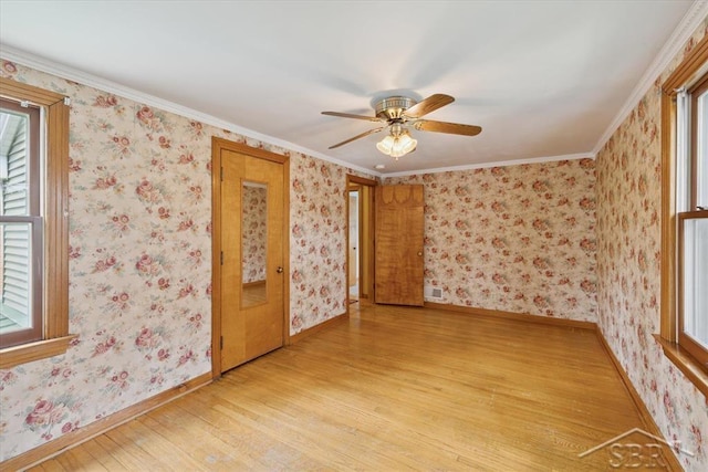 2505 Court St, Saginaw, MI 48602 - unfurnished room featuring light wood-type flooring, ceiling fan, baseboards, and ornamental molding