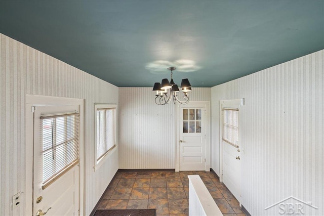 2505 Court St, Saginaw, MI 48602 - doorway to outside featuring a chandelier, stone tile floors, and wallpapered walls