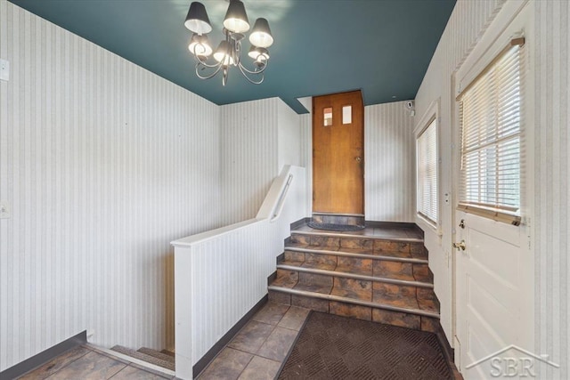 2505 Court St, Saginaw, MI 48602 - staircase with wallpapered walls and a chandelier