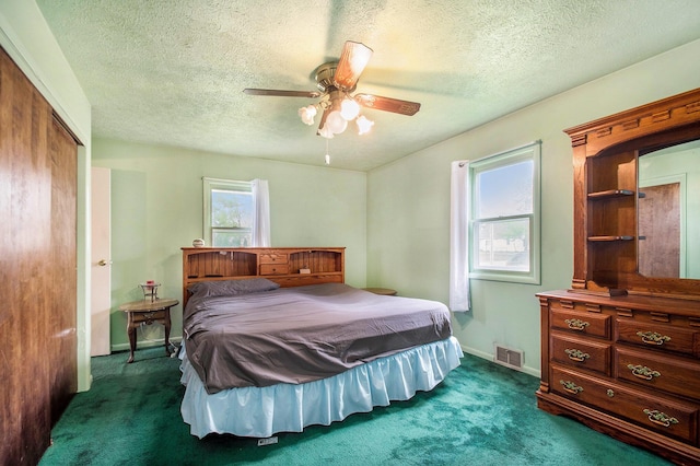 202 Maple St, Three Oaks, MI 49128 - bedroom featuring dark carpet, a closet, a textured ceiling, ceiling fan, and baseboards