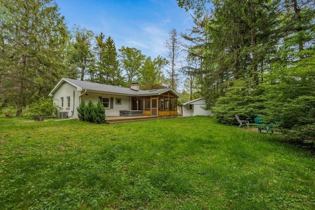 12270 Linden Ave, Sawyer, MI 49125 - back of house featuring a sunroom, a chimney, a yard, central air condition unit, and a deck