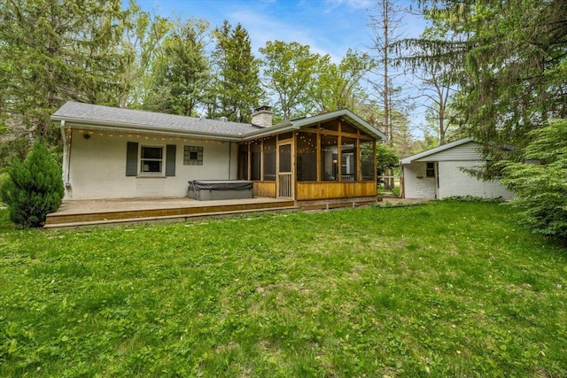 12270 Linden Ave, Sawyer, MI 49125 - rear view of house featuring a hot tub, a chimney, a sunroom, and a yard