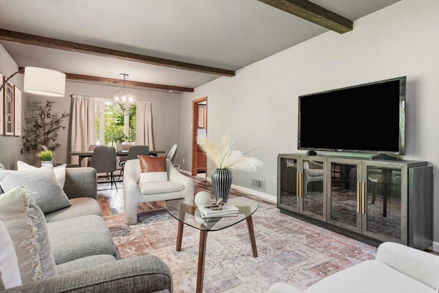 12270 Linden Ave, Sawyer, MI 49125 - living room featuring a chandelier, beam ceiling, baseboards, and wood finished floors