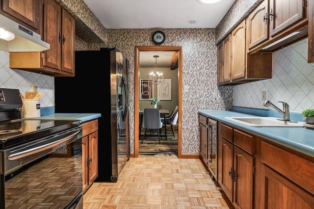 12270 Linden Ave, Sawyer, MI 49125 - kitchen featuring black range with electric stovetop, under cabinet range hood, a sink, and tasteful backsplash