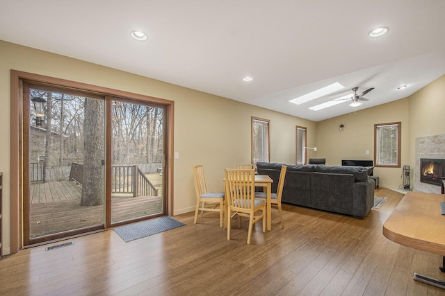 7362 30th St SE, Ada, MI 49301 - dining space with wood finished floors, a skylight, ceiling fan, recessed lighting, and lofted ceiling