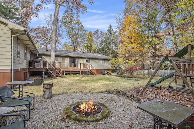 7362 30th St SE, Ada, MI 49301 - view of yard with a fire pit, stairs, a deck, and a playground