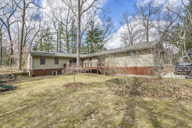 7362 30th St SE, Ada, MI 49301 - back of property with stairs, a deck, a chimney, and a lawn