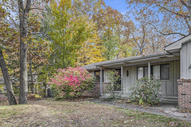 7362 30th St SE, Ada, MI 49301 - view of front of home featuring brick siding and board and batten siding