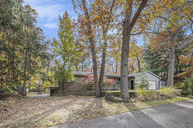 7362 30th St SE, Ada, MI 49301 - view of front of property featuring board and batten siding and a garage