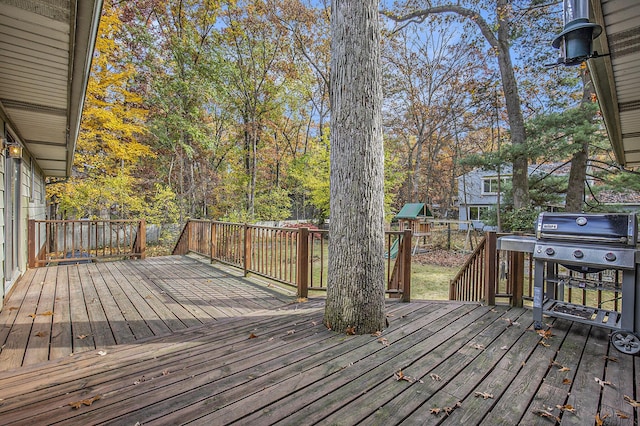 7362 30th St SE, Ada, MI 49301 - wooden deck featuring a playground and grilling area