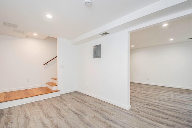 7362 30th St SE, Ada, MI 49301 - finished below grade area featuring wood finished floors, stairs, electric panel, recessed lighting, and baseboards