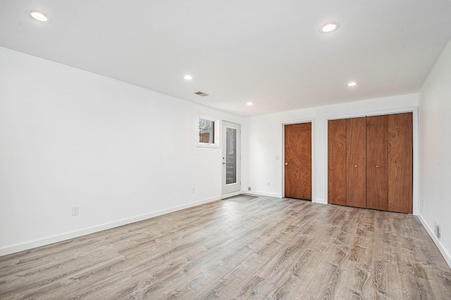 7362 30th St SE, Ada, MI 49301 - unfurnished bedroom featuring two closets, recessed lighting, light wood-style floors, and baseboards