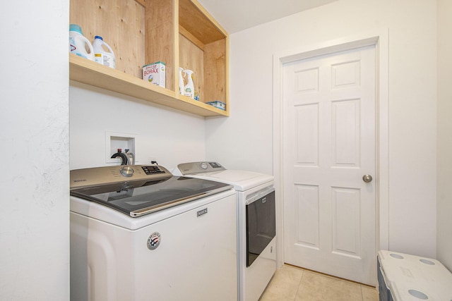 7362 30th St SE, Ada, MI 49301 - laundry area with washing machine and clothes dryer and light tile patterned floors