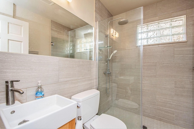 7362 30th St SE, Ada, MI 49301 - bathroom with toilet, a tile shower, tile walls, and vanity