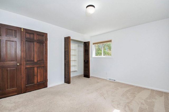 7362 30th St SE, Ada, MI 49301 - unfurnished bedroom with light carpet, baseboards, and a closet