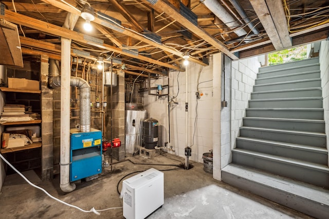 50902 Magician Lk Rd, Dowagiac, MI 49047 - unfinished below grade area with stairway, a water pressure tank, a heating unit, and water heater