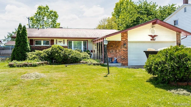 4107 Windward Dr, Lansing, MI 48911 - ranch-style home with an attached garage, brick siding, and a front yard