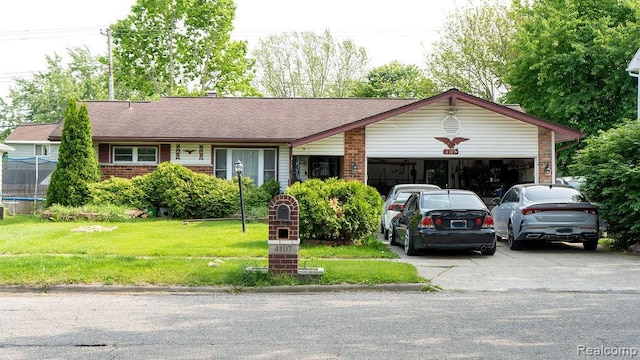 4107 Windward Dr, Lansing, MI 48911 - single story home featuring a garage, driveway, a front yard, and brick siding