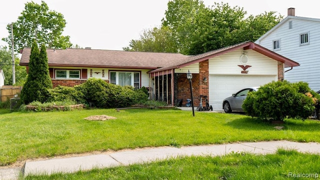 4107 Windward Dr, Lansing, MI 48911 - ranch-style home with a garage, brick siding, and a front yard