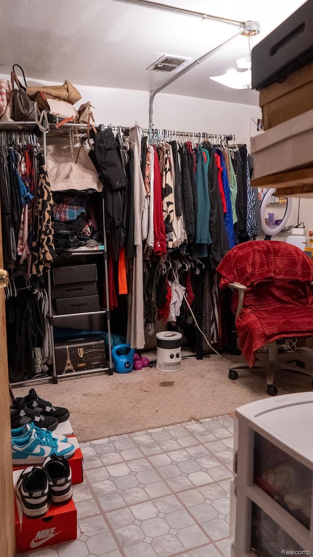 4107 Windward Dr, Lansing, MI 48911 - walk in closet with tile patterned floors and carpet