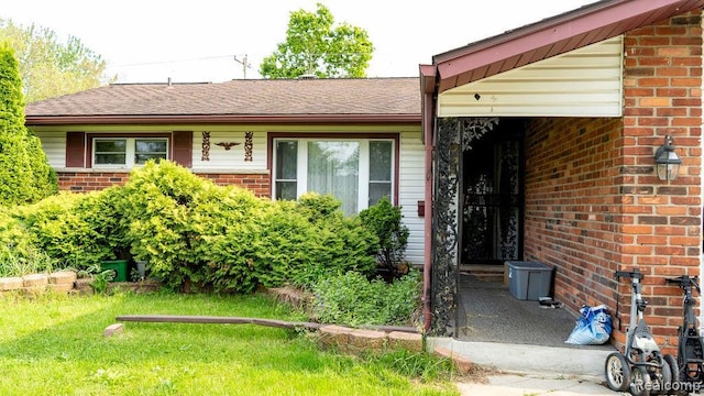 4107 Windward Dr, Lansing, MI 48911 - property entrance featuring brick siding and a lawn
