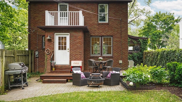 1512 Shadford Rd, Ann Arbor, MI 48104 - back of property featuring brick siding, a balcony, an outdoor fire pit, entry steps, and a patio area