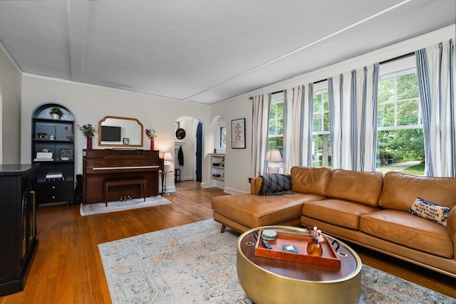 1512 Shadford Rd, Ann Arbor, MI 48104 - living room featuring arched walkways, healthy amount of natural light, wood finished floors, and baseboards
