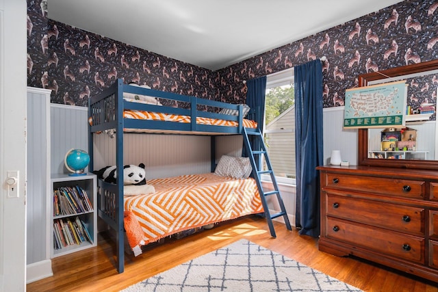 1512 Shadford Rd, Ann Arbor, MI 48104 - bedroom featuring wallpapered walls, a wainscoted wall, and wood finished floors