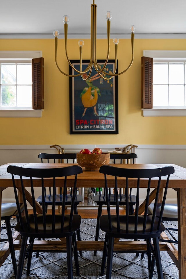 1512 Shadford Rd, Ann Arbor, MI 48104 - dining room with healthy amount of natural light, a chandelier, ornamental molding, and wood finished floors