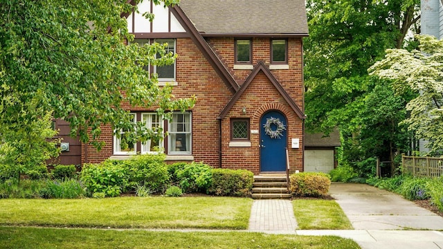 1512 Shadford Rd, Ann Arbor, MI 48104 - english style home featuring brick siding, a shingled roof, concrete driveway, and a garage