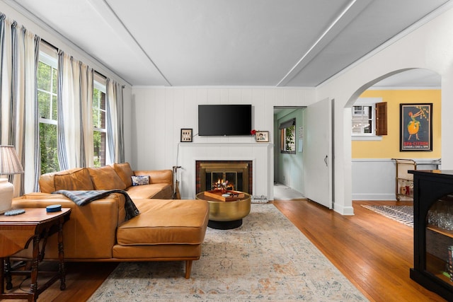 1512 Shadford Rd, Ann Arbor, MI 48104 - living room with arched walkways, wood finished floors, a fireplace, baseboards, and crown molding