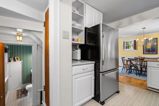 1512 Shadford Rd, Ann Arbor, MI 48104 - kitchen with freestanding refrigerator, open shelves, white cabinets, a chandelier, and hanging light fixtures