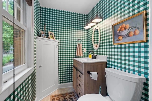 1512 Shadford Rd, Ann Arbor, MI 48104 - bathroom with wallpapered walls, vanity, baseboards, toilet, and tile patterned floors